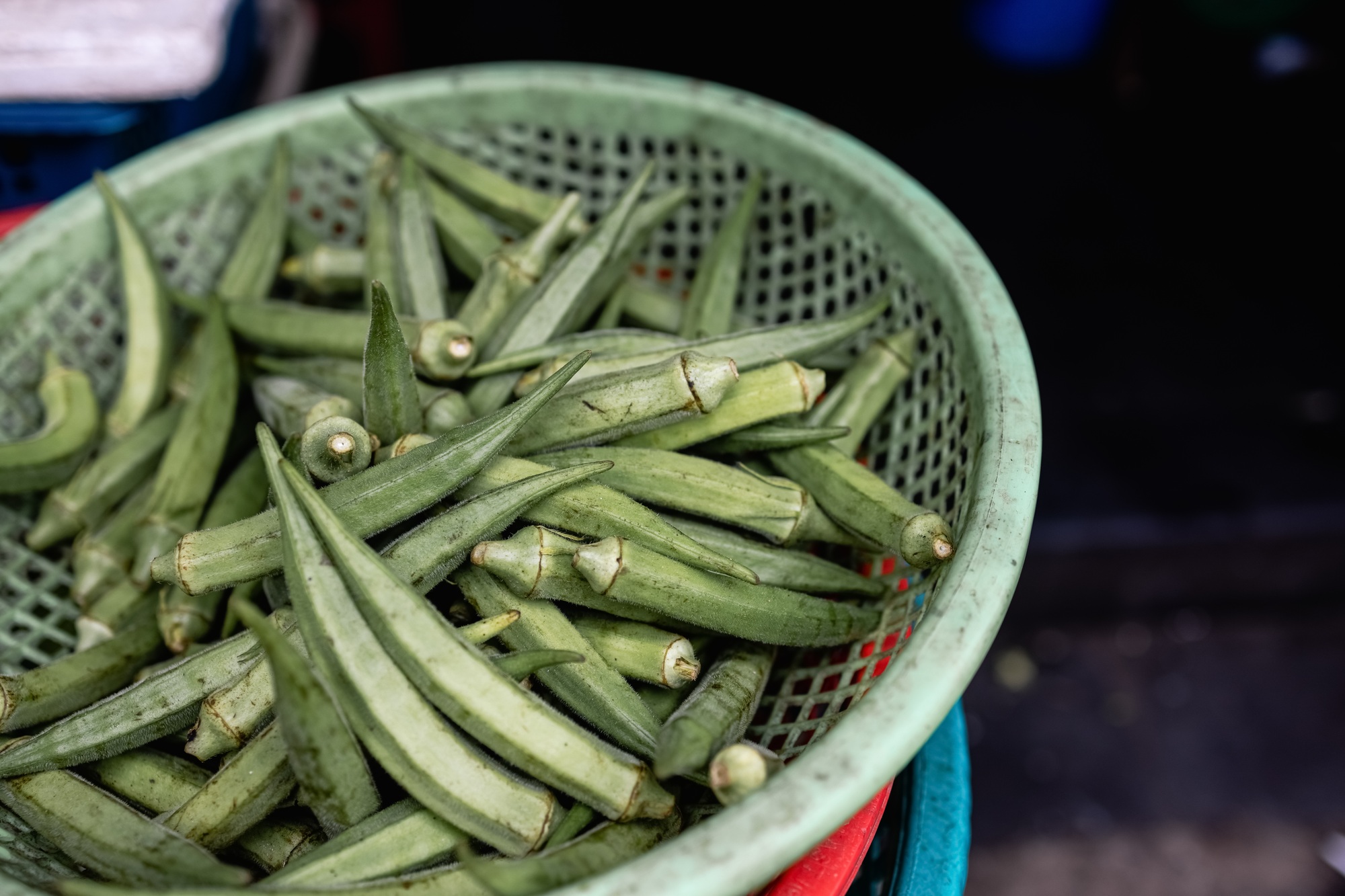 Lots of fresh and green and organic Okra (Lady Finger) in basket at a local Indian vegetable market.